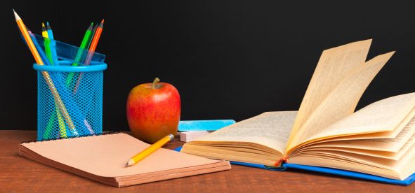 back-school-concept-blackboard-with-books-apple-wooden-desk_127657-8632